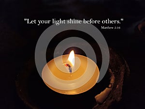 Bible verse quote - Let your light shines before others. Matthew 5:16. With one candle light in the night on dark background.