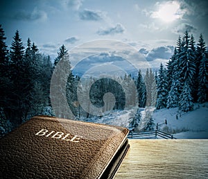 Bible with winter mountain scenics