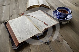 Bibles and cup of tea on wood table