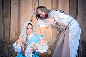 Biblical characters taking a selfie while joking in nativity scene