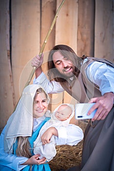 Biblical characters taking selfie while smiling in a nativity scene