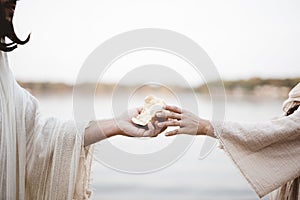 Biblical scene - of Jesus Christ handing out bread with a blurred background