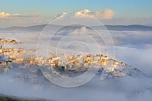 Biblical village Cana of Galilee Kafr Kanna in morning fog, Nazareth in Israel