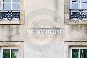 Bibliotheque sign french text on facade of Old French Village Building Municipal Library in city center