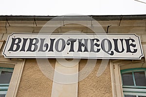 Bibliotheque sign french text on facade of Old French Village Building Municipal Library locale in city center