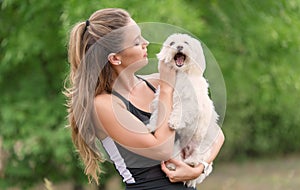 Bichon bolognese dog with beautiful in the park