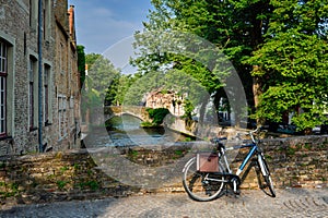 Bicyccle on a bridge near canal and old houses. Bruges Brugge , Belgium