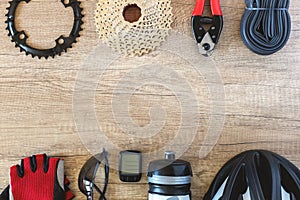 Bicycle accessories and parts on brown wooden background