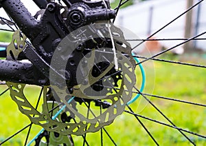 Bicycle brake disc on green grass background.