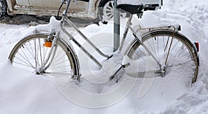 bicycle buried in snow, winter background outdoors in winter times in europe