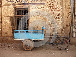 Bicycle cart by old wall