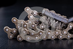 Bicycle chain and metal brush for cleaning dirt. Care of the bicycle& x27;s drive system
