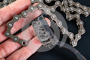 Bicycle chain and metal brush for cleaning dirt. Care of the bicycle's drive system