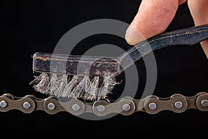 Bicycle chain and metal brush for cleaning dirt. Care of the bicycle's drive system