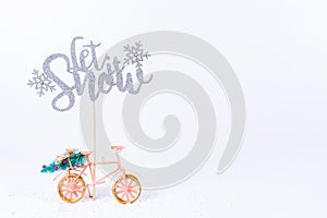 Bicycle with Christmas tree in the snow on white background. Holiday season, Christmas concept.