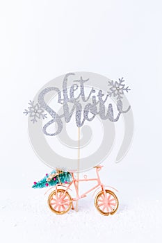 Bicycle with Christmas tree in the snow on white background. Holiday season, Christmas concept.