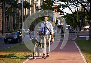 Bicycle, city and portrait of happy businessman for travel, morning commute and walking to work. Professional, urban