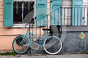 This bicycle is color coordinated with the shutters next to it