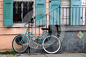 This bicycle is color coordinated with the shutters next to it photo