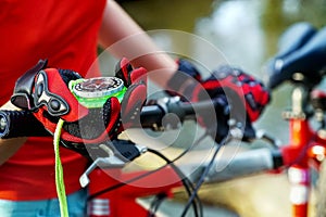 Bicycle compass in hands. Cyclist looking for way.