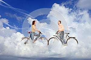 Bicycle couple man and woman meeting on clouds