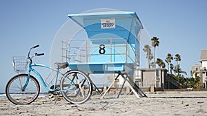 Bicycle cruiser bike by ocean beach California coast USA. Summer sea shore. Cycle by lifeguard tower