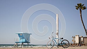 Bicycle cruiser bike by ocean beach California coast USA. Summer sea shore. Cycle by lifeguard tower