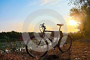 A bicycle at dawn near the pond. outdoor exercise