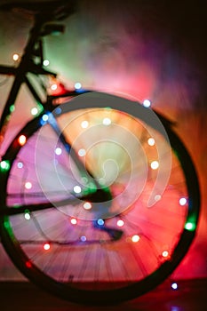 Bicycle decorated with Christmas lights out of focus