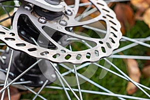 Bicycle disk brakes close up, grey metal disc attached to bike wheel, effective popular mountain bicycle brakes