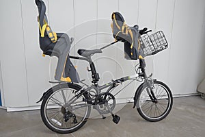 A bicycle with dual child baby seats mounted installed