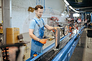 Bicycle factory, assembly line, chain installation photo