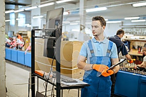 Bicycle factory, worker poses at assembly line