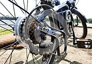 Bicycle gear wheels in close up with mechanic gears cassette and chain at the rear wheel of folding bike