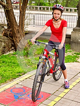 Bicycle girl wearing helmet and glass ciclyng .