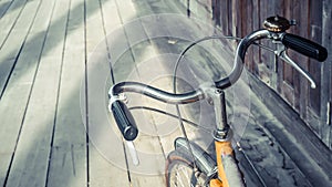 Bicycle handle bar close up on wooden floor background