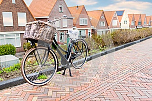 bicycle with handlebar pannier parked at curb