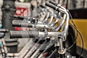 Bicycle handlebars or metallic steering wheels in row in Berlin