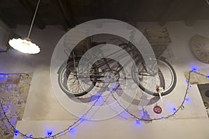 Bicycle hanging on the wall with Christmas lights