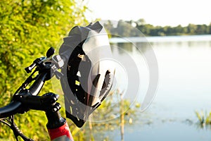 bicycle helmet on the handlebars of an e-bike at sunset in nature, cycling helmet