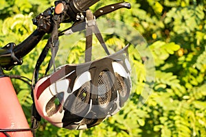 bicycle helmet on the handlebars of an e-bike at sunset in nature, cycling helmet