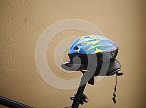 Bicycle helmet on top of black bicycle seat