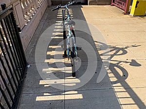 Bicycle and its shadow on LaSalle bridge in Chicago Loop during evening commute photo