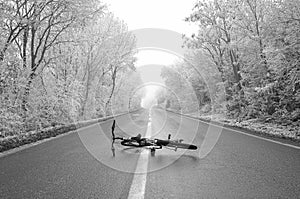 Bicycle laying on the forest road