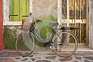 Bicycle leaning against colorful wall, Burano, Italy