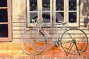 Bicycle leaning against house wall