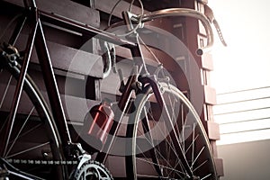 Bicycle leaning against the wall fence in the dark