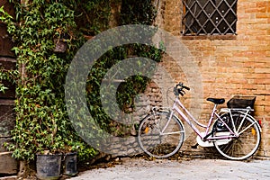 A bicycle leaning against a wall of a small Tuscan town