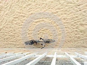 Bicycle leaning on the beach wall