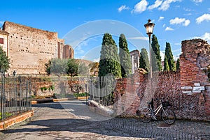 Bicycle leaning on the wall and lamppost in Rome.